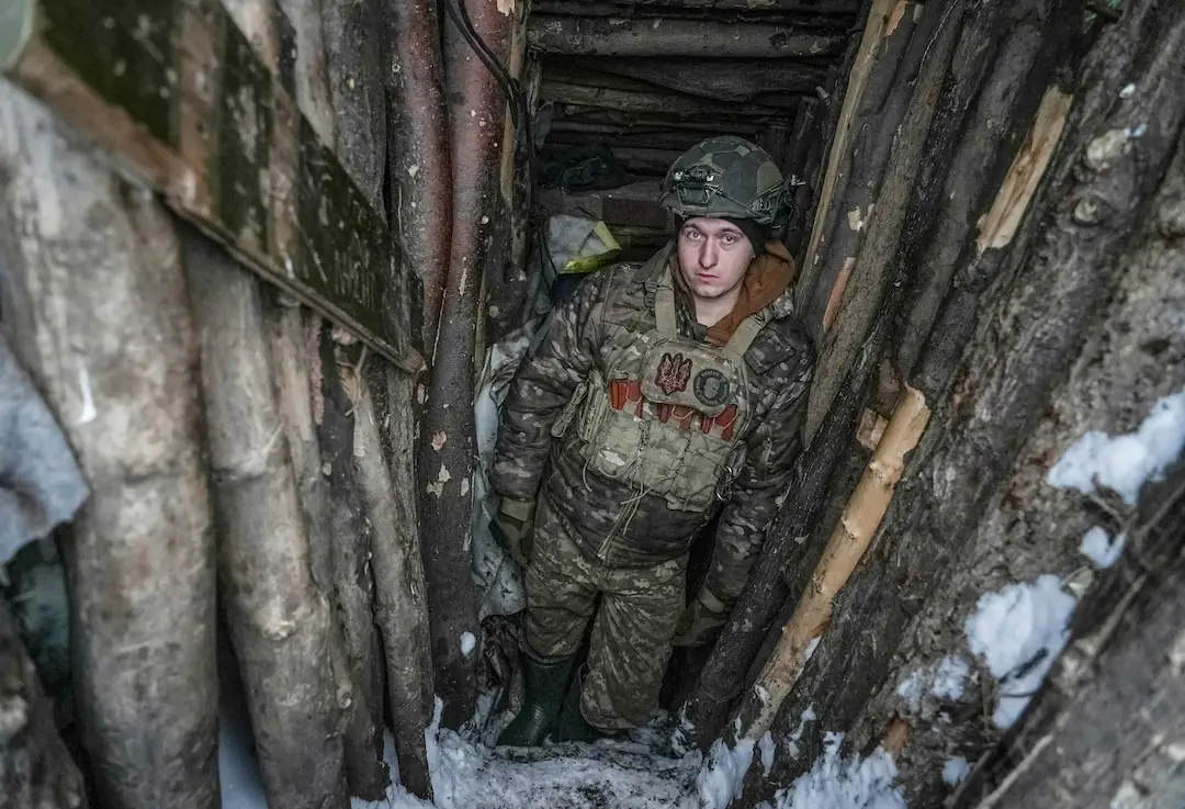 Soldier in narrow trench tunnel with snow